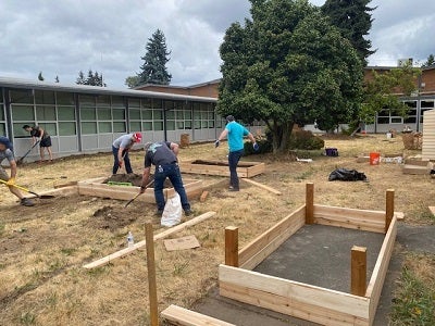 volunteers building planter boxes for rainier view gardens